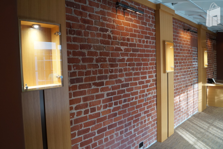 Exposed Red brick with well lit display windows.