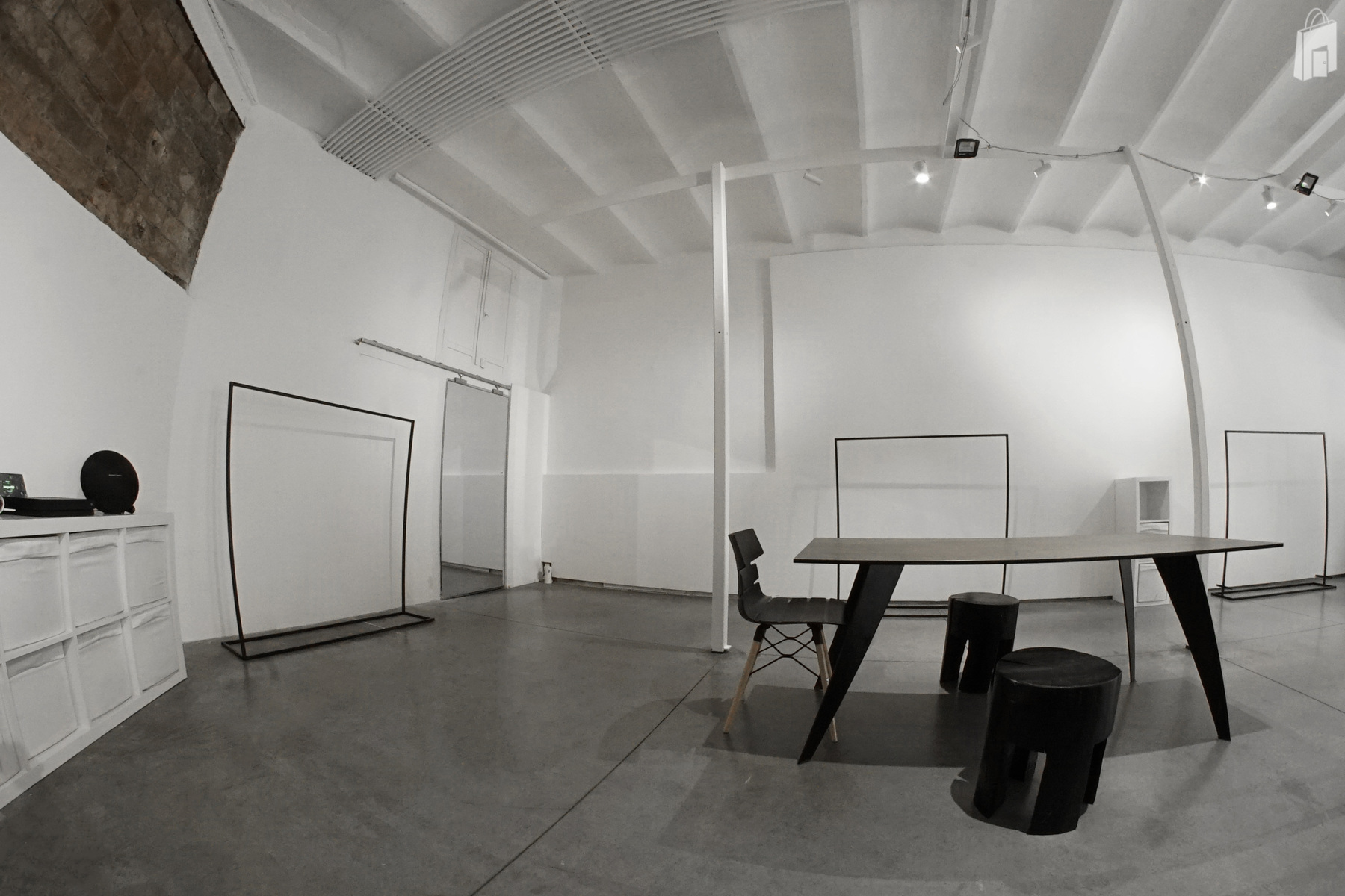 The mirror is hiding the storage and the bathroom in the back of the showroom