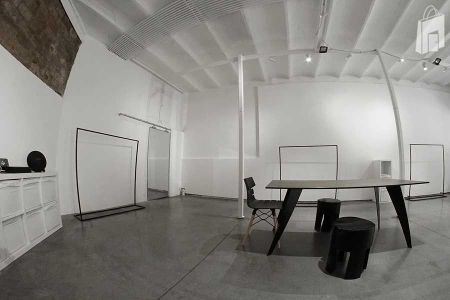 The mirror is hiding the storage and the bathroom in the back of the showroom