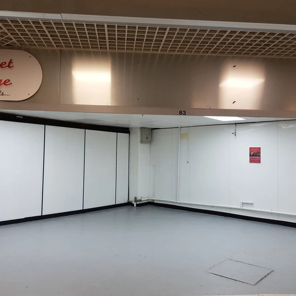 Shop unit in a large, busy indoor market hall.