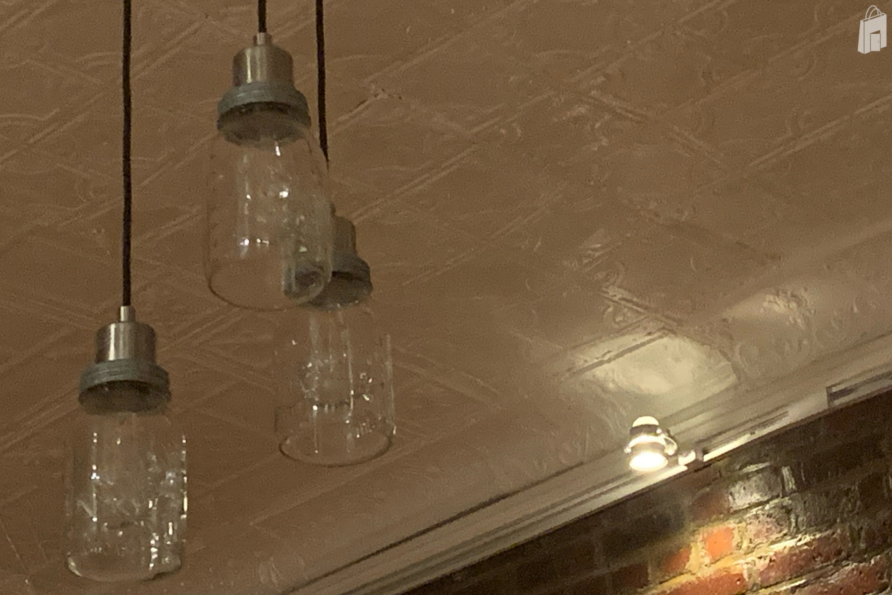 Mason jar pendant lighting with track lights also floating led lights above the 3/4 wallpapered wall
