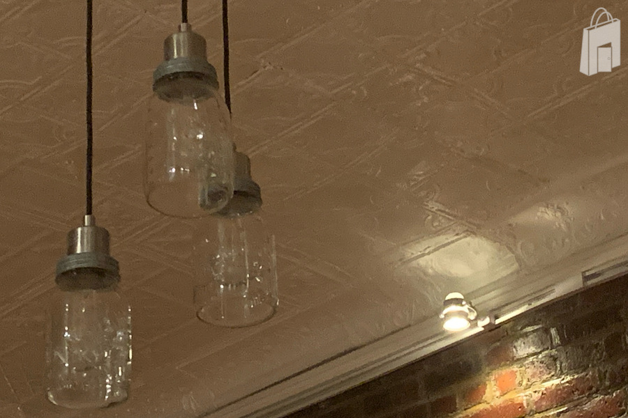 Mason jar pendant lighting with track lights also floating led lights above the 3/4 wallpapered wall