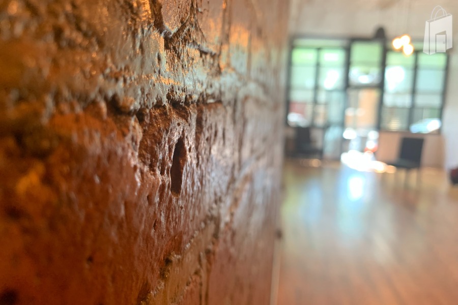 Exposed brick wall Main room