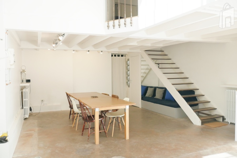 A removable wooden panel separating the main room from the kitchen